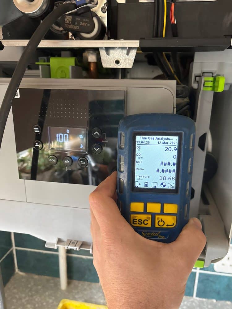 Flue gas analyser taking a reading during a Home Heroes boiler service