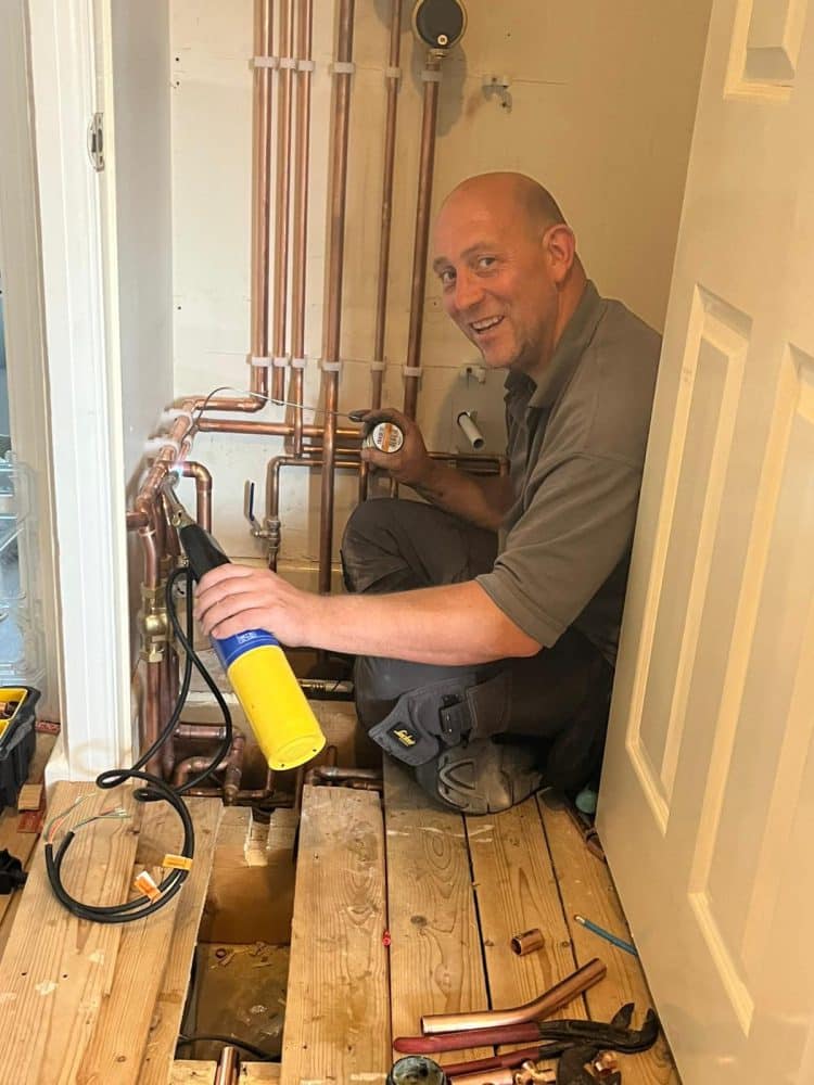 Home Heroes engineer soldering copper heating pipework in a North Dorset home