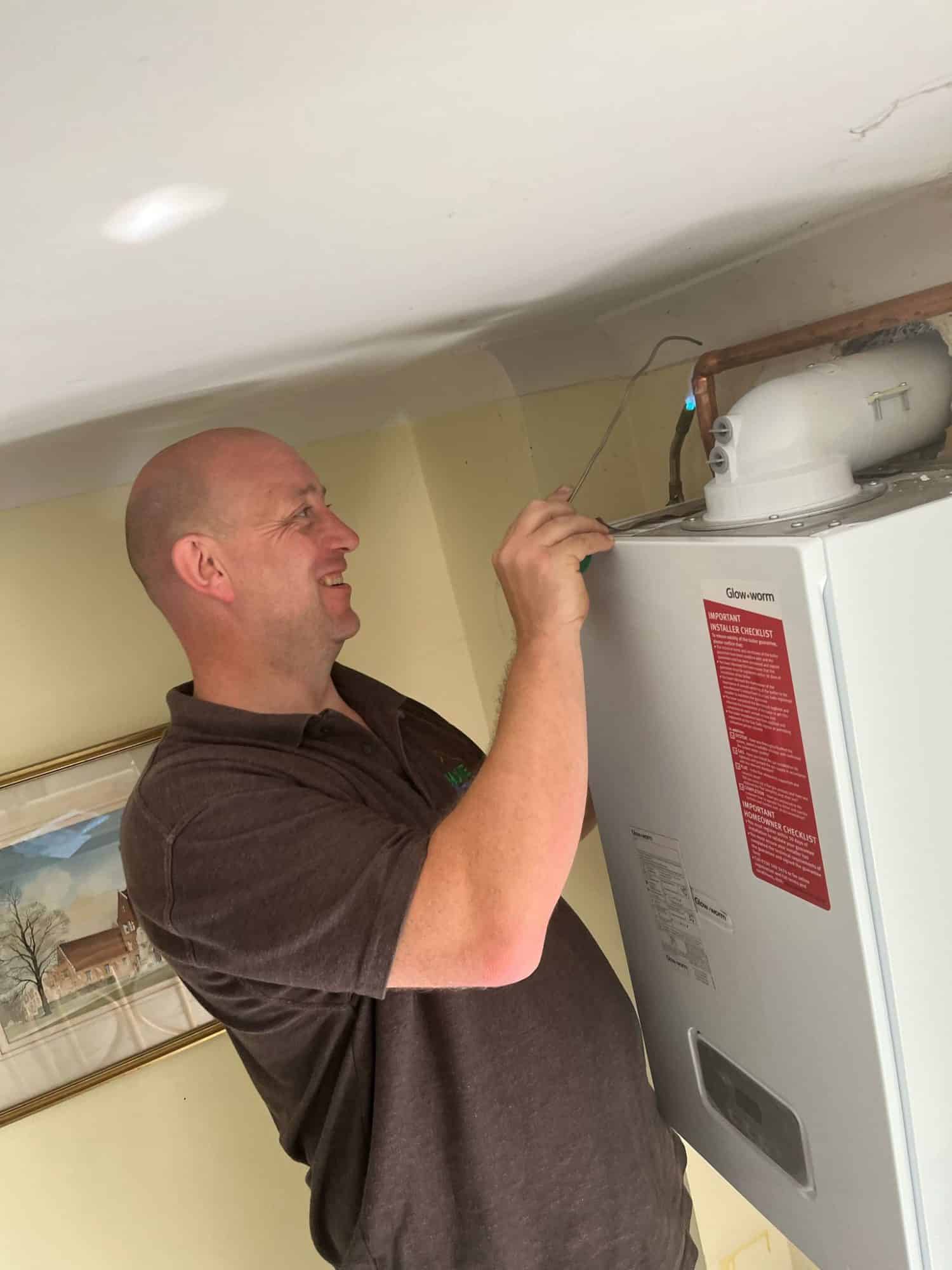 Matt Underwood of Home Heroes working on a wall-mounted gas boiler