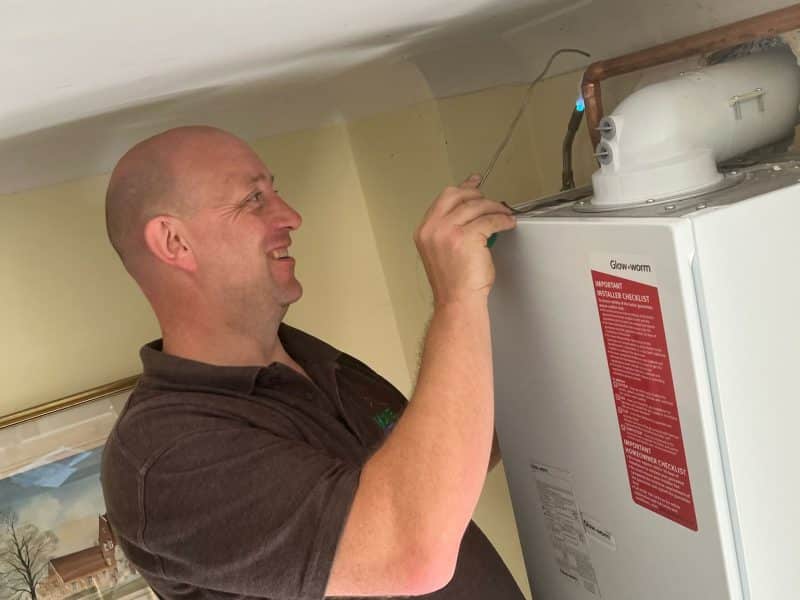 Matt Underwood of Home Heroes working on a wall-mounted gas boiler