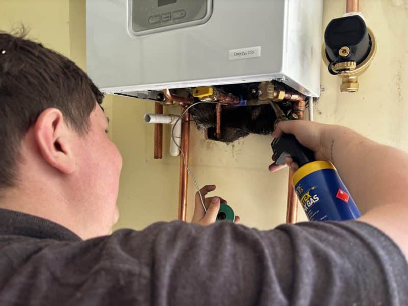 Owen Edwards of Home Heroes servicing a gas boiler in Dorset