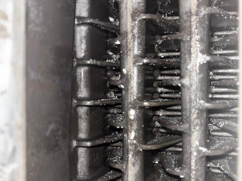 Corroded and sludged heat exchanger fins from a heating system needing a power flush